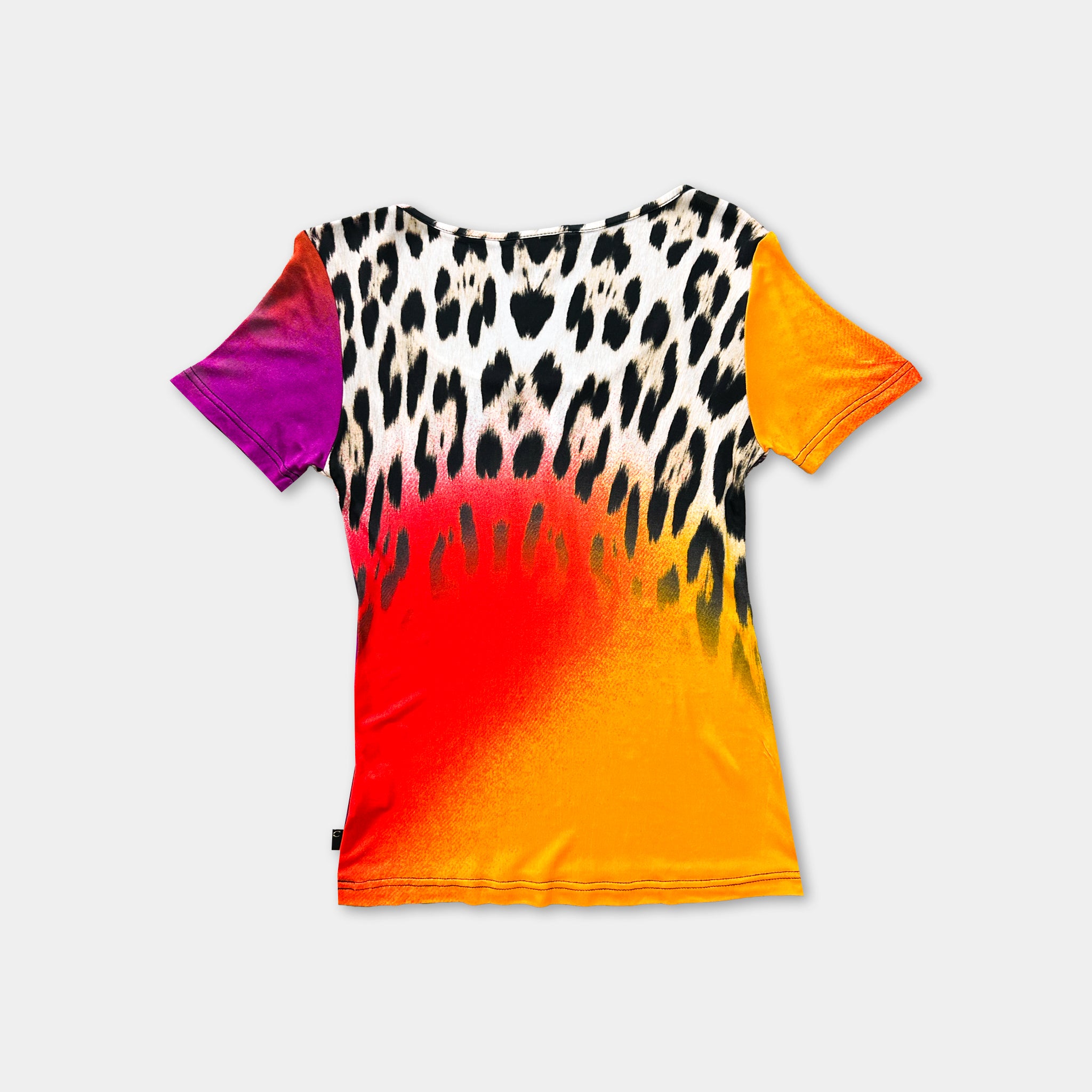 A colorful t-shirt with a leopard print pattern in shades of orange, yellow, and black.
