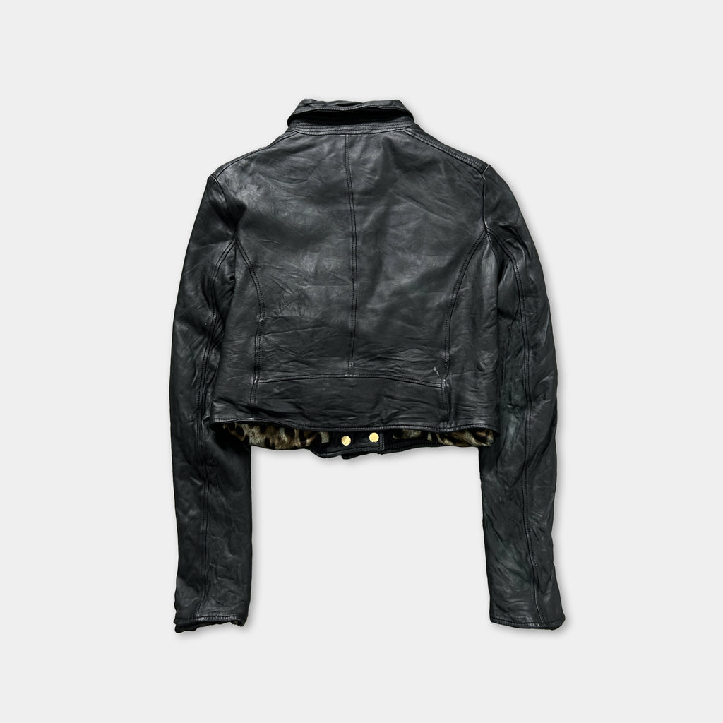A black leather jacket with a collar and long sleeves, displayed against a plain background.