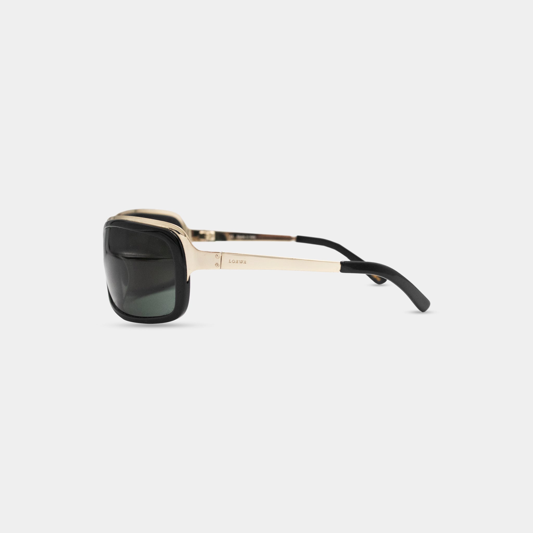 A pair of stylish sunglasses with a gold frame and black lenses.