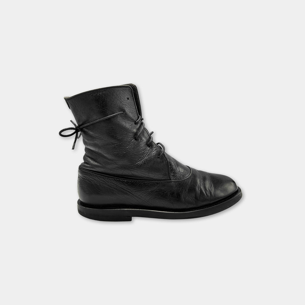 A single black leather boot with a lace-up closure.