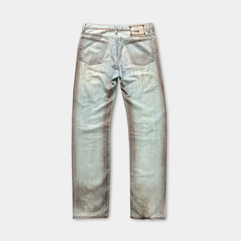 A pair of light blue denim jeans with a faded, distressed appearance.