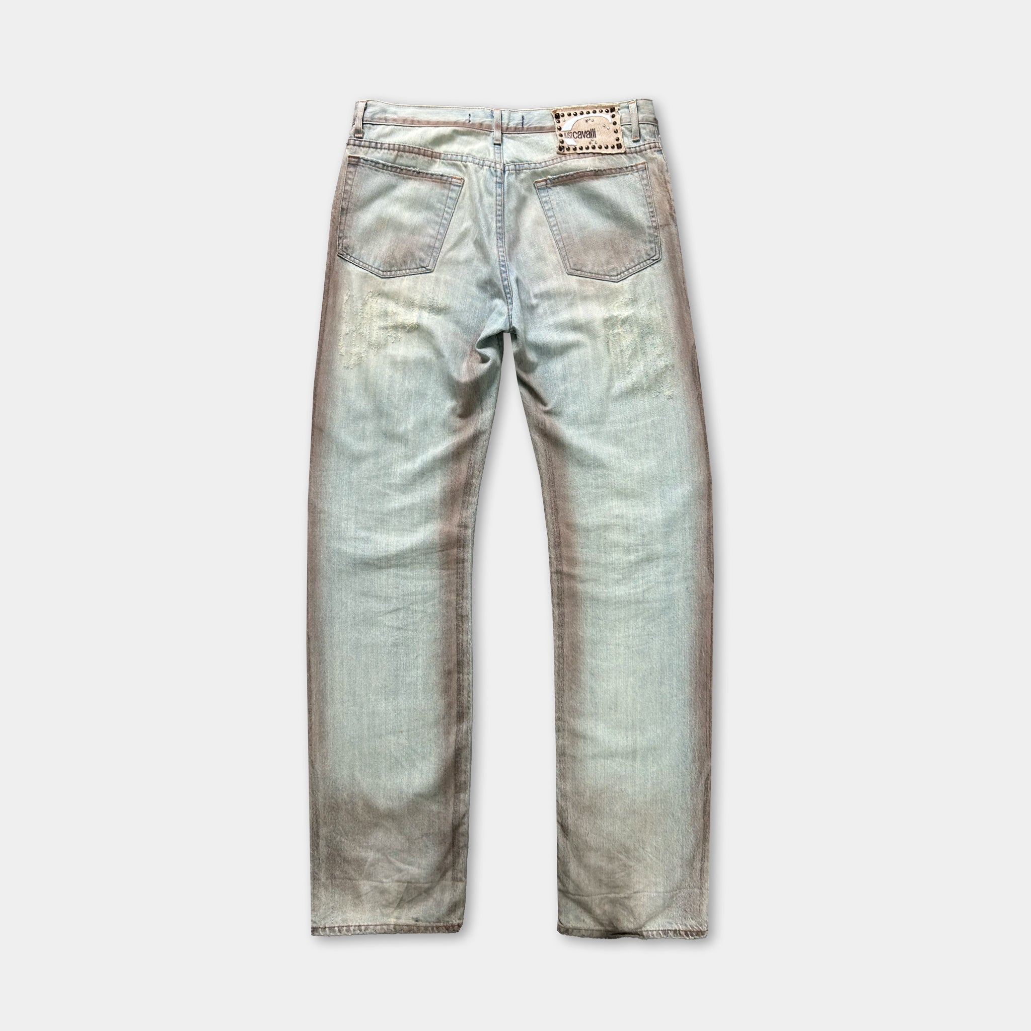 A pair of light blue denim jeans with a faded, distressed appearance.