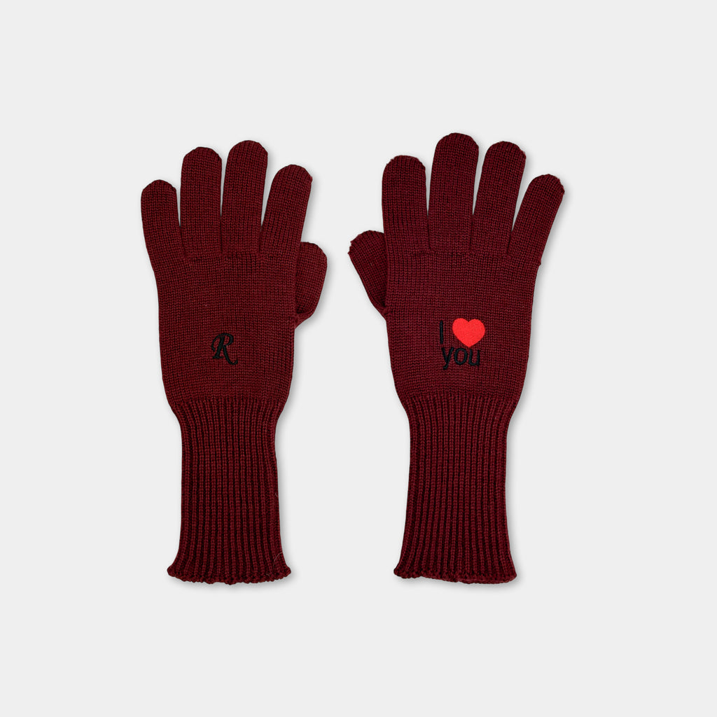 A pair of burgundy-colored gloves with the words "I love you" embroidered on them.