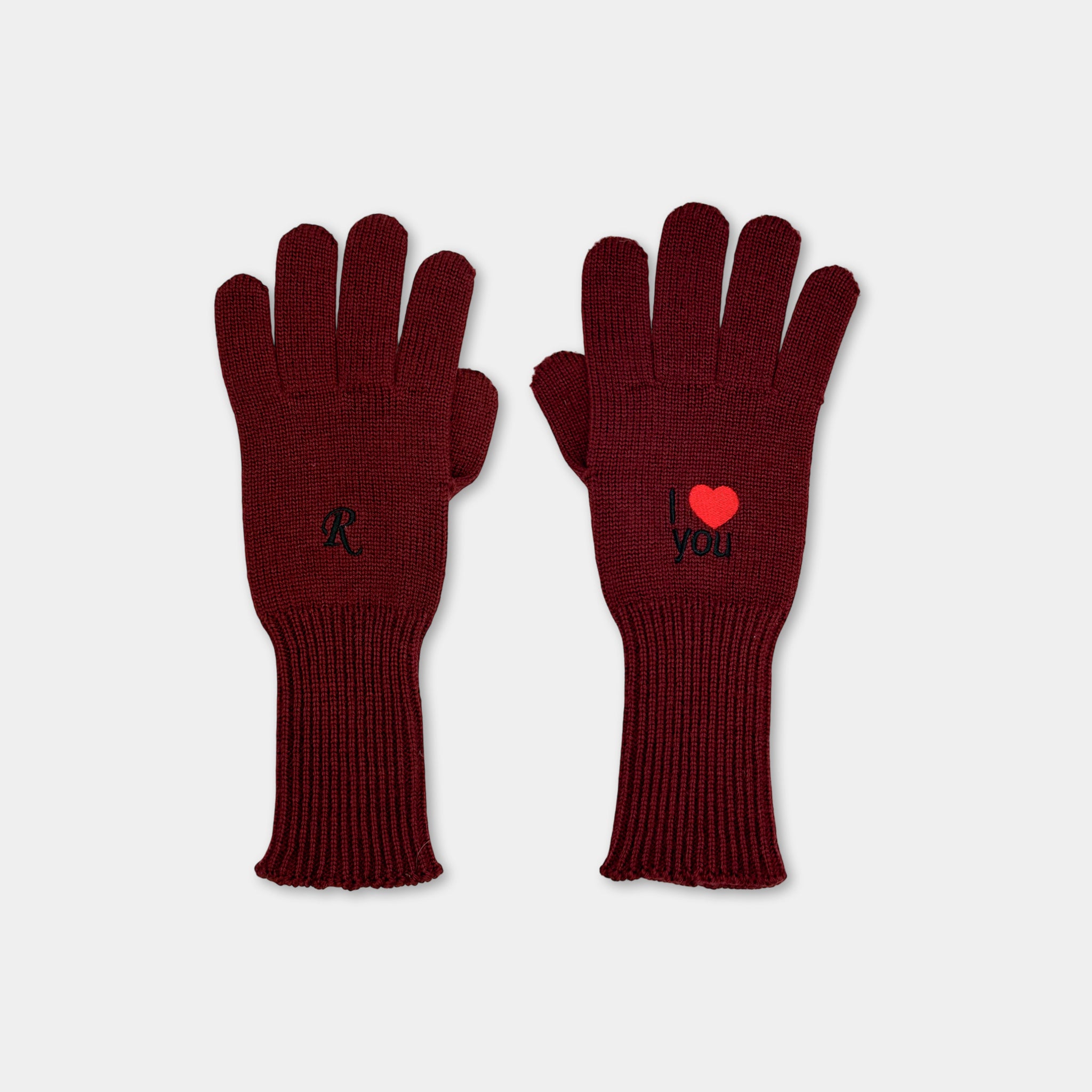 A pair of burgundy-colored gloves with the words "I love you" embroidered on them.