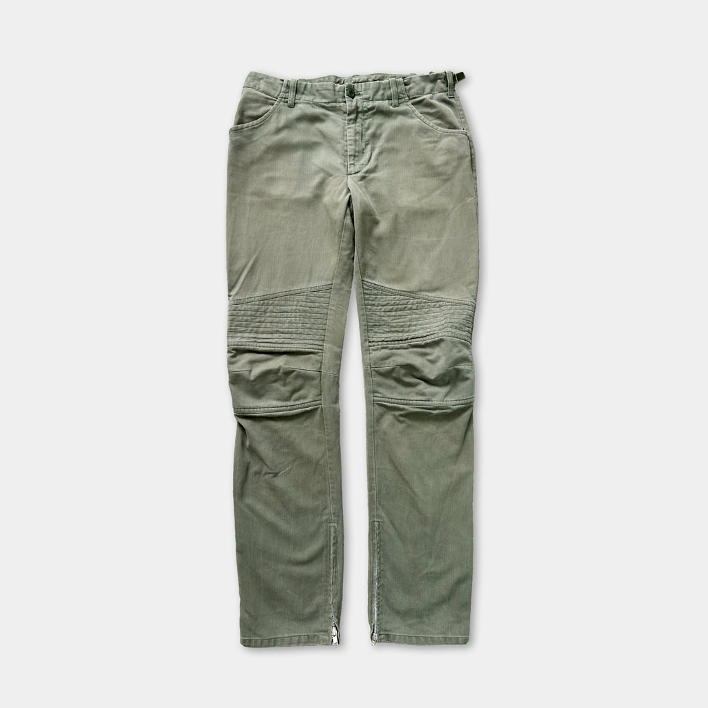 A pair of olive green cargo pants with a zipper detail on the front.