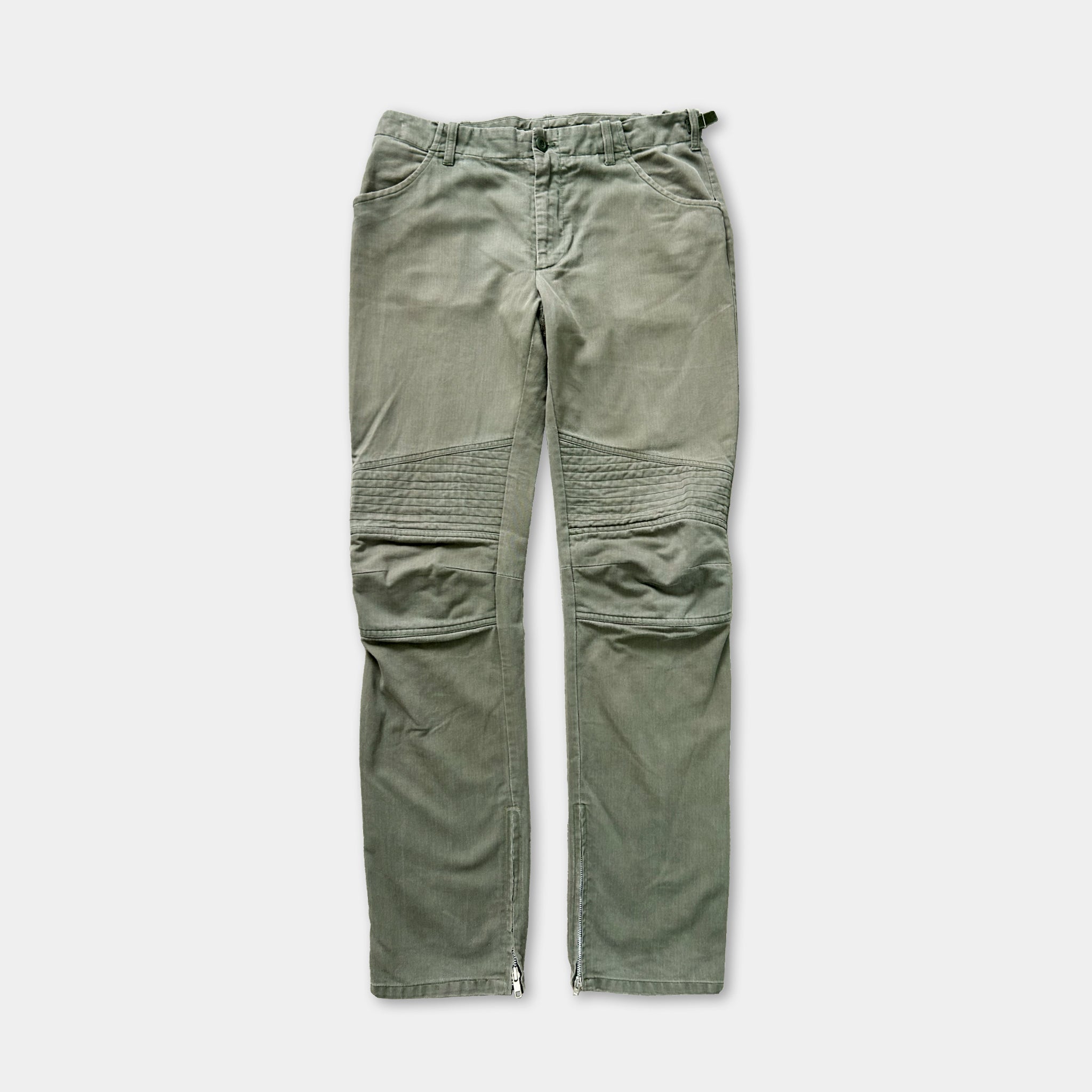 A pair of olive green cargo pants with a zipper detail on the front.