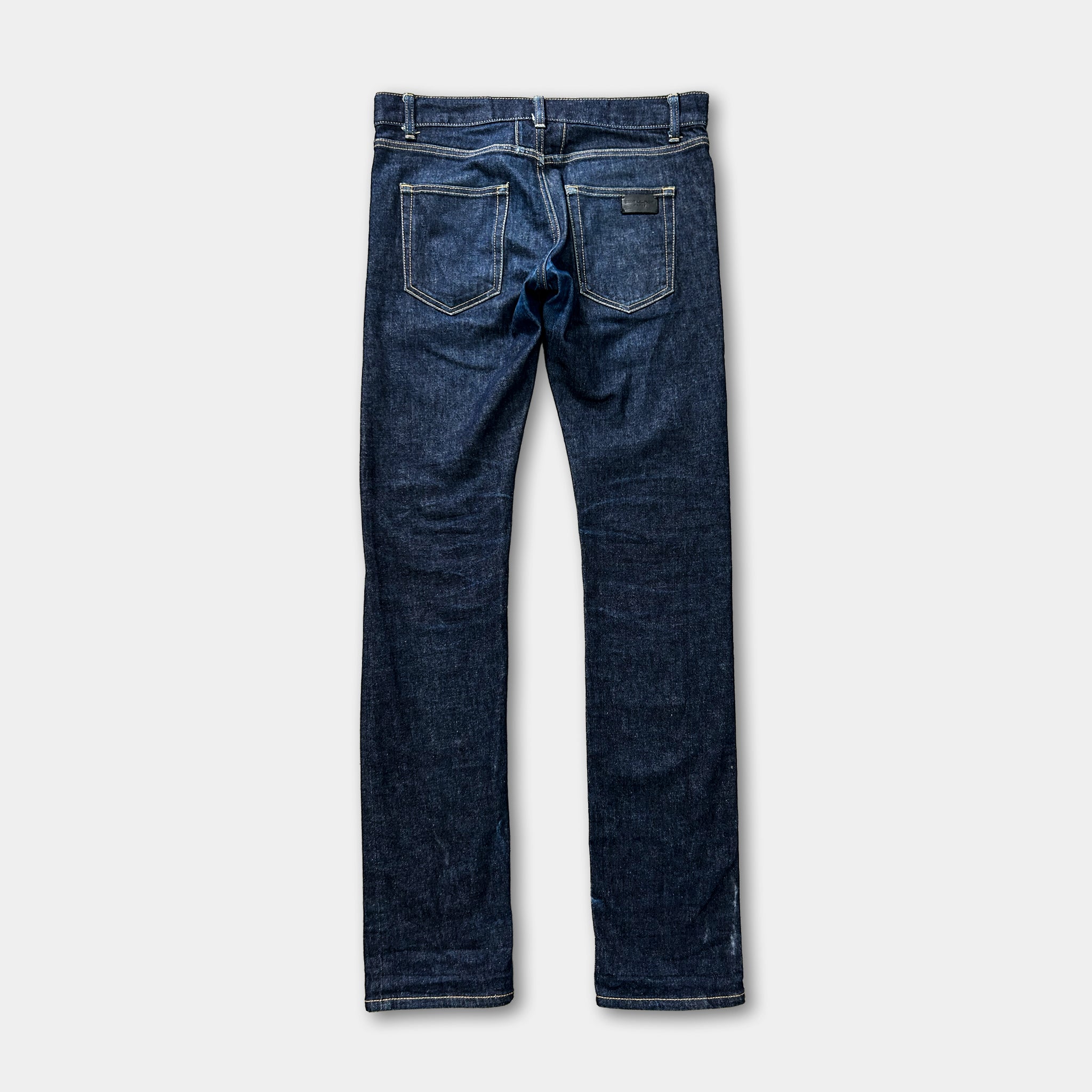 A pair of blue jeans with a pocket on the back and a zipper.