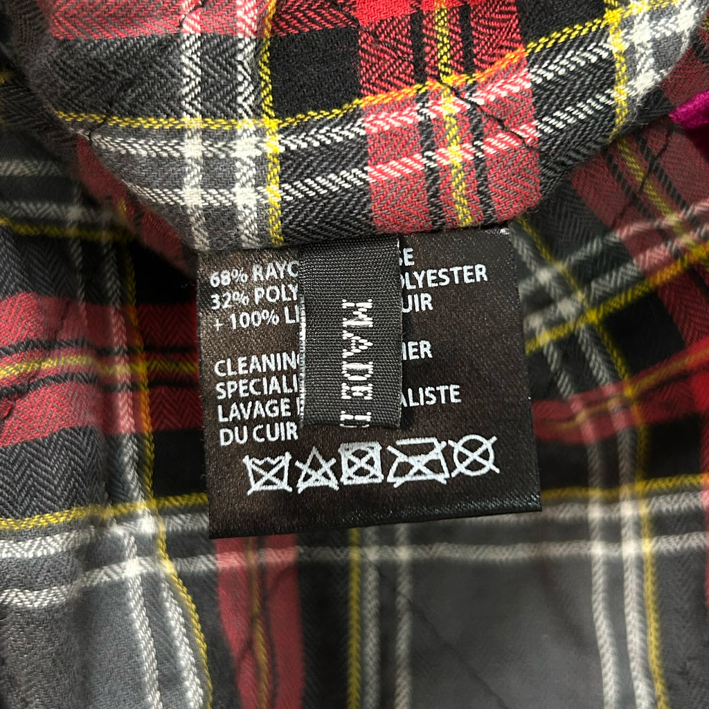 a close-up view of a fabric label with text and symbols, likely indicating the care instructions for the fabric.