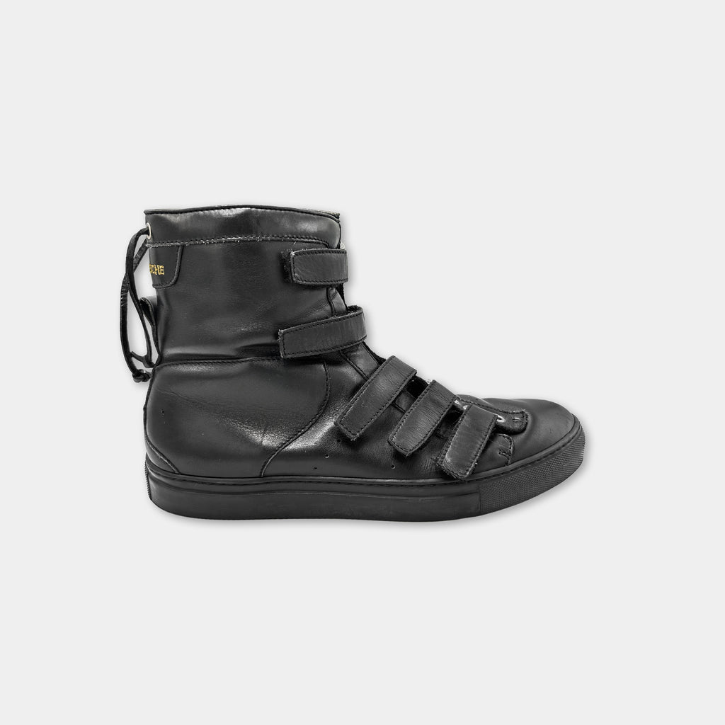 A black leather boot with multiple straps and buckles.