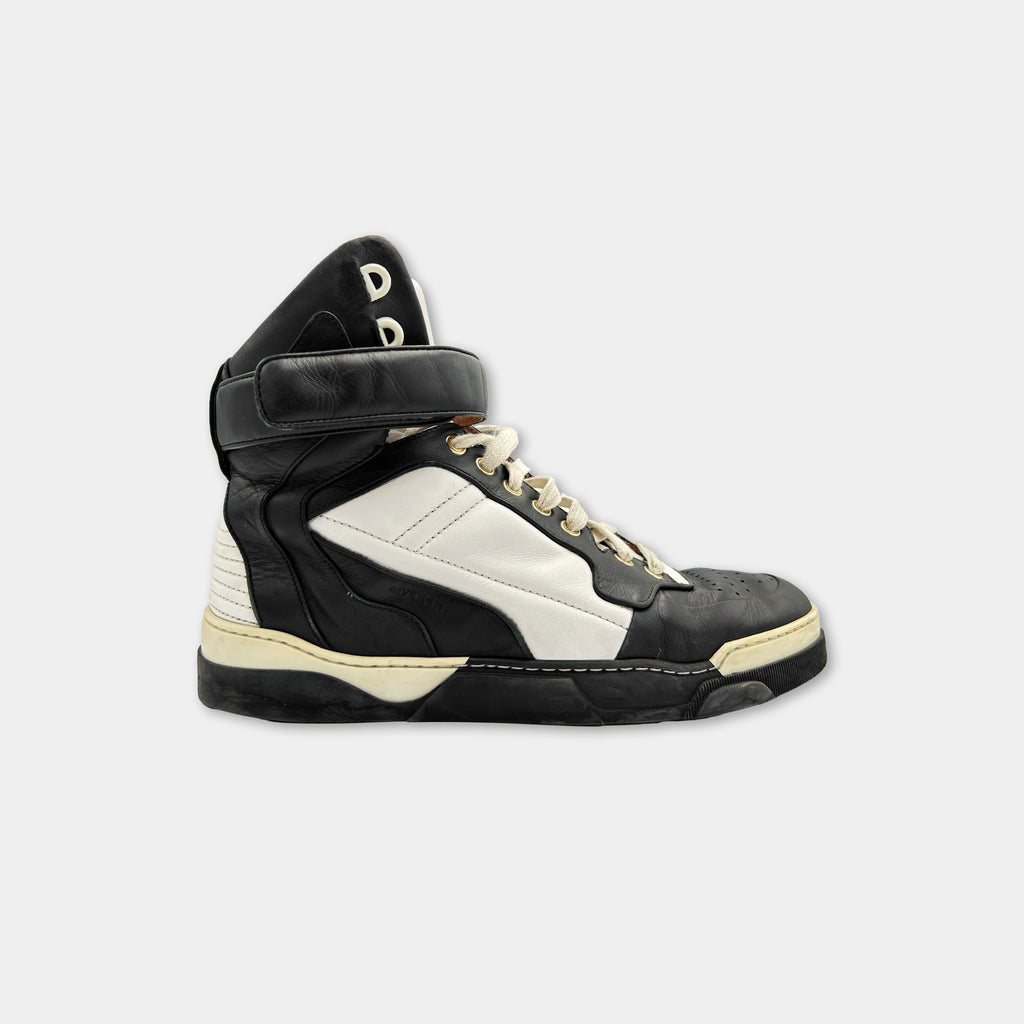 A black and white high-top sneaker with a distinctive design.