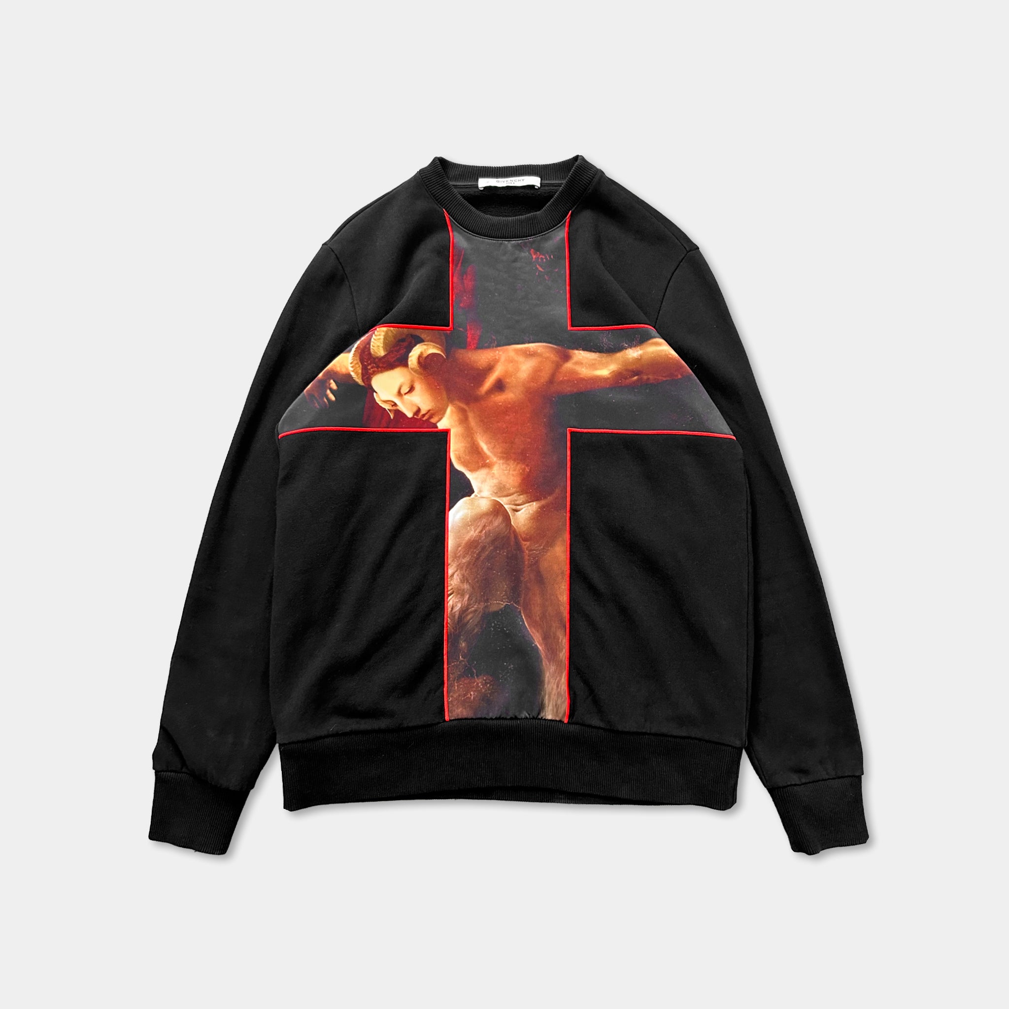a black sweatshirt with a large red cross on the front.