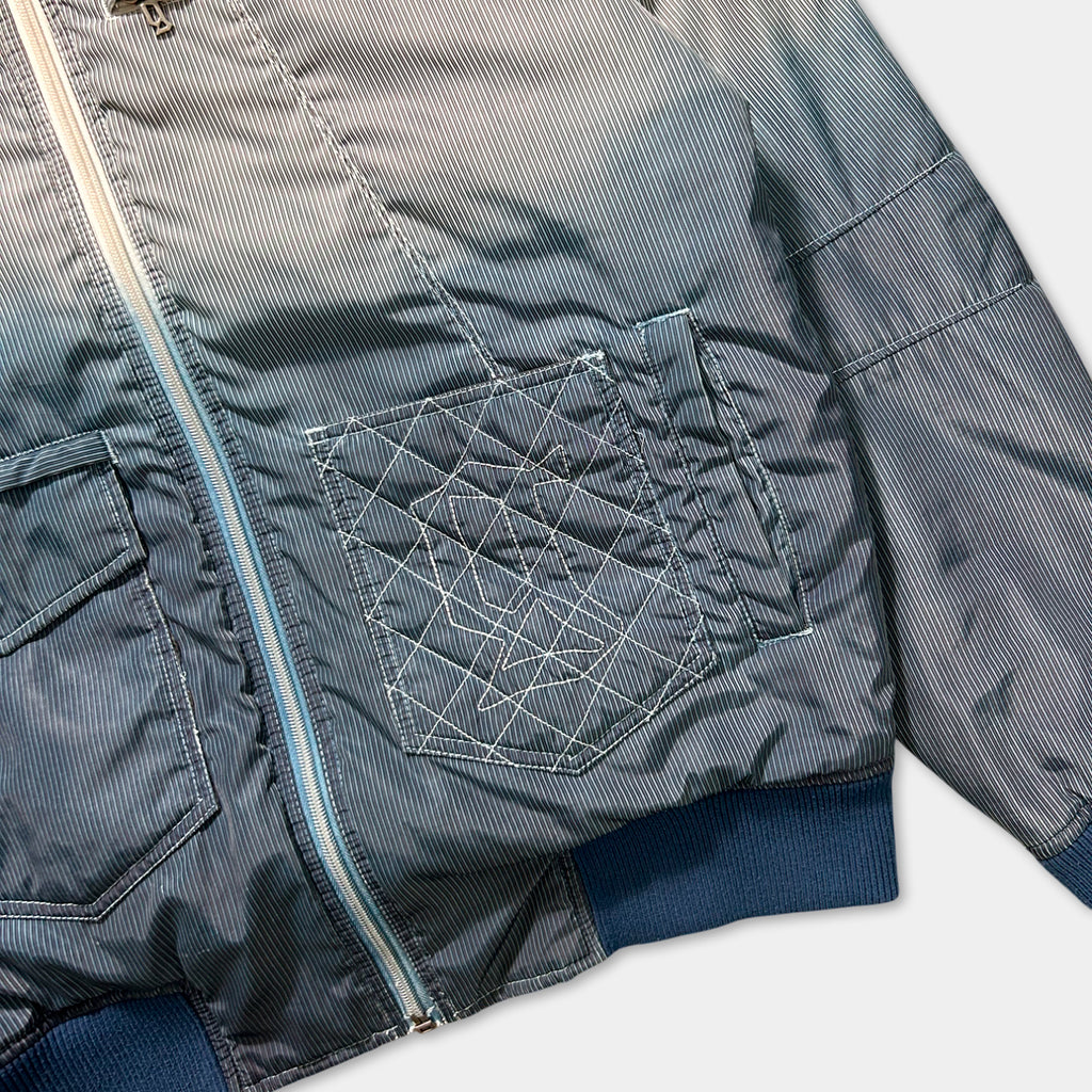 A close-up view of a striped jacket with a zipper and pockets.