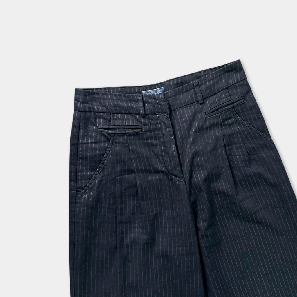 A pair of black pinstriped trousers with a waistband and pockets.