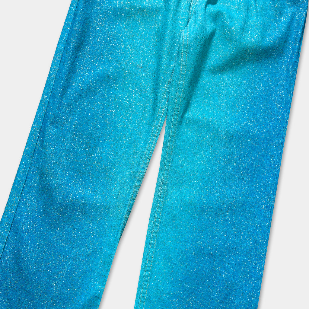 A pair of blue jeans with a glittery, sparkly texture.