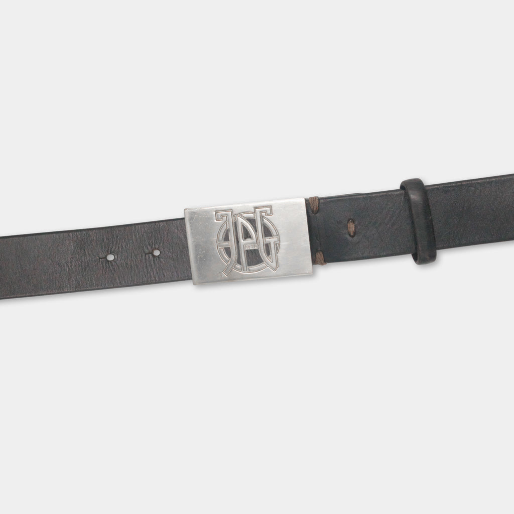 A black leather belt with a metal buckle featuring a monogrammed logo.