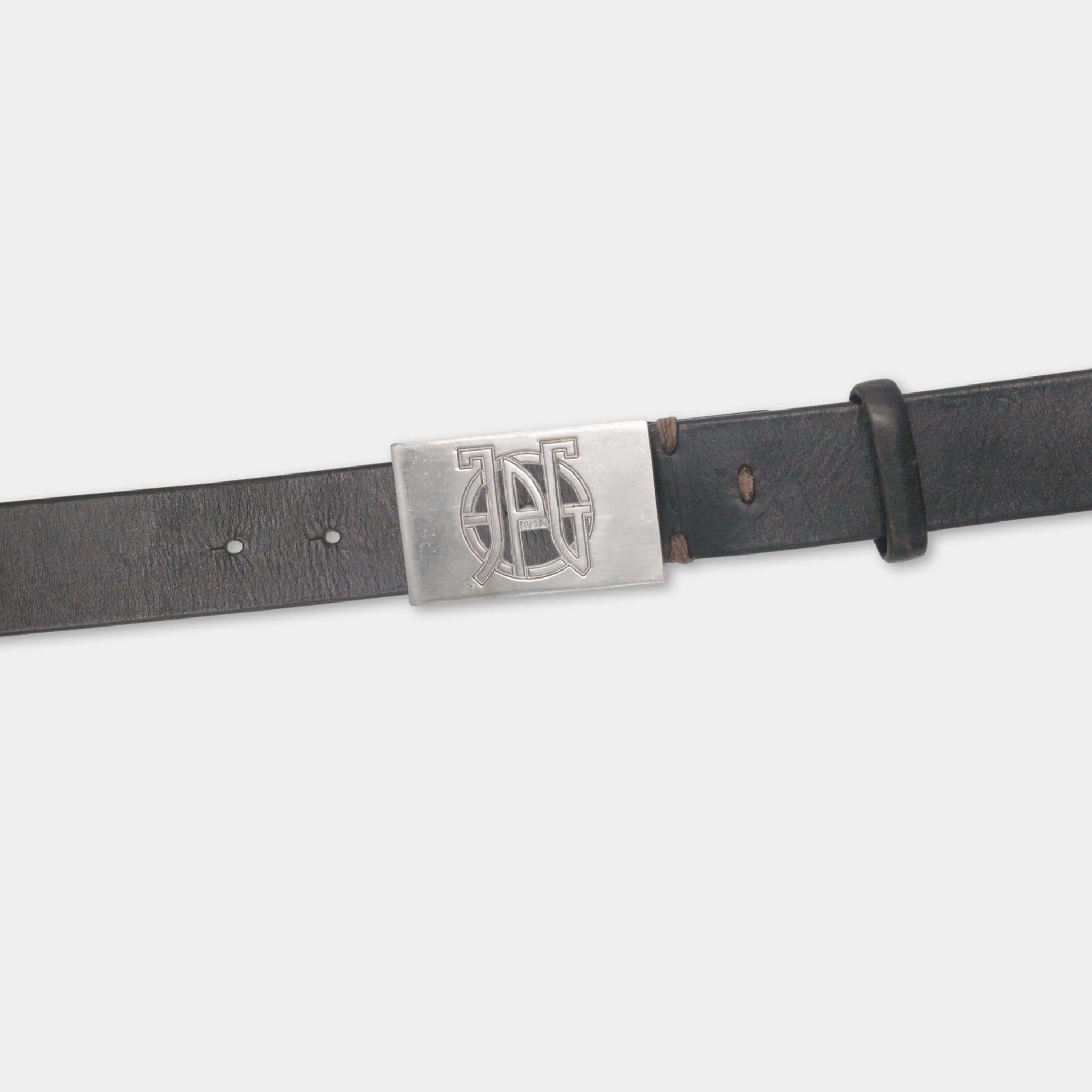 A black leather belt with a metal buckle featuring a monogrammed logo.