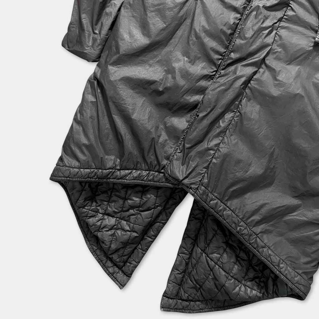 a close-up view of a black, textured fabric, possibly a piece of clothing or a textile.