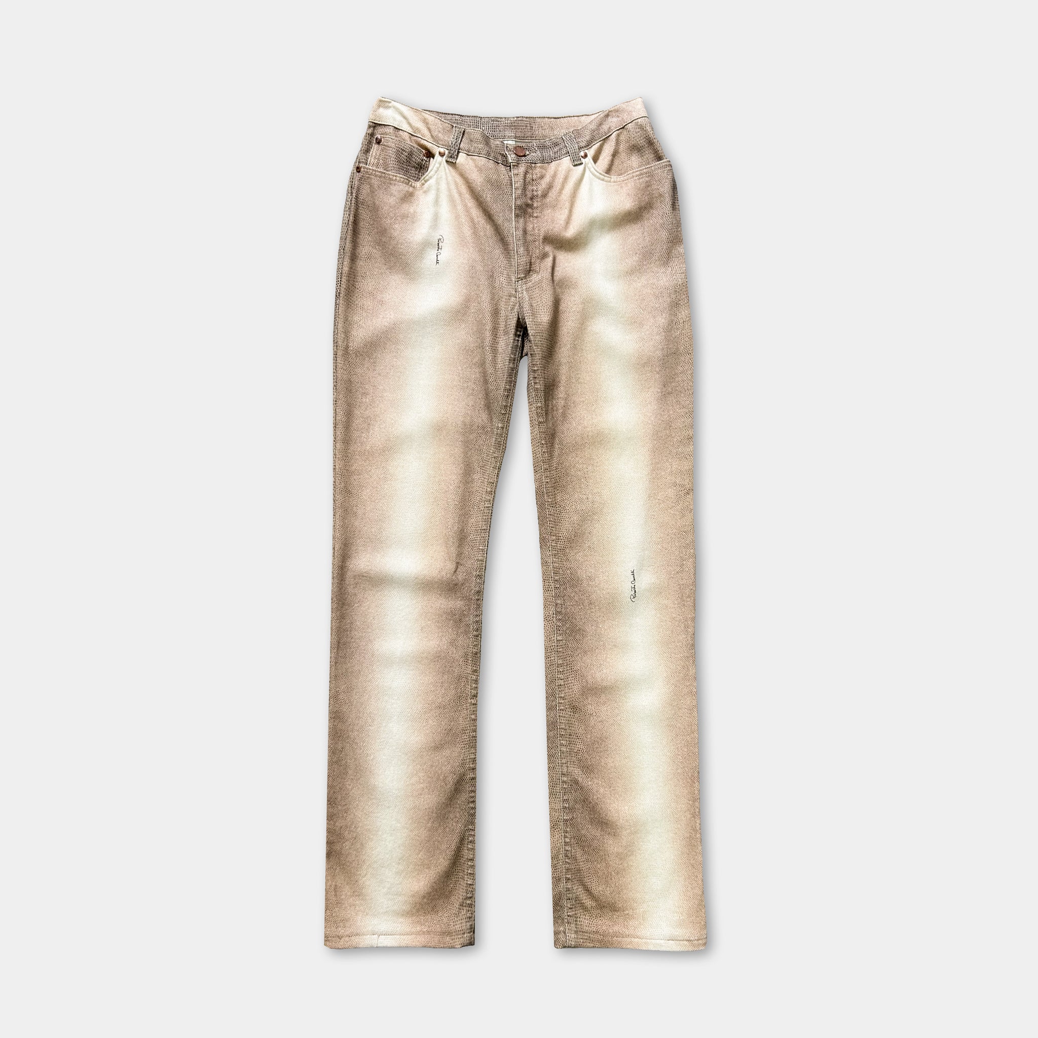 A pair of tan-colored jeans with visible wear and tear, including holes in the knees.