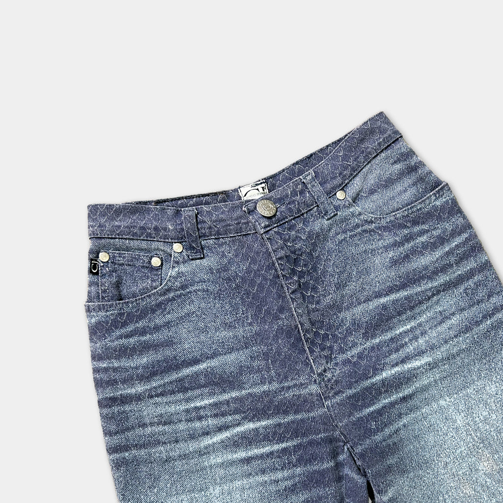 A pair of blue jeans with a distinctive snake skin pattern.