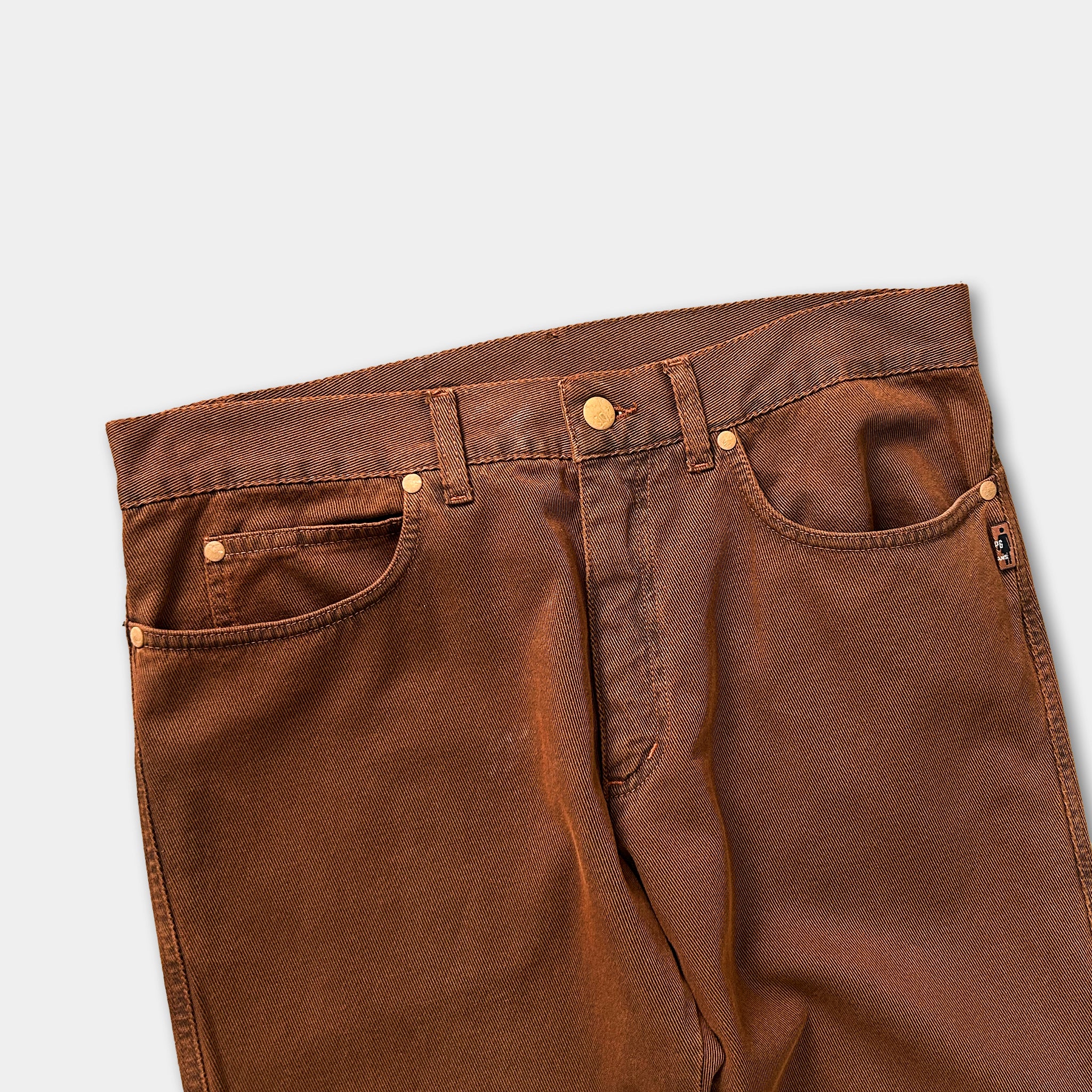 A pair of brown jeans with a button waistband and pockets.