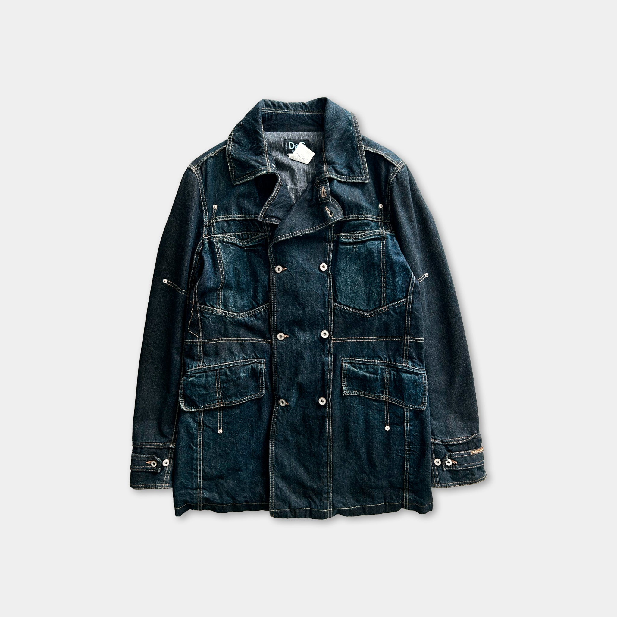 A dark blue denim jacket with multiple pockets and buttons, displayed against a plain background.
