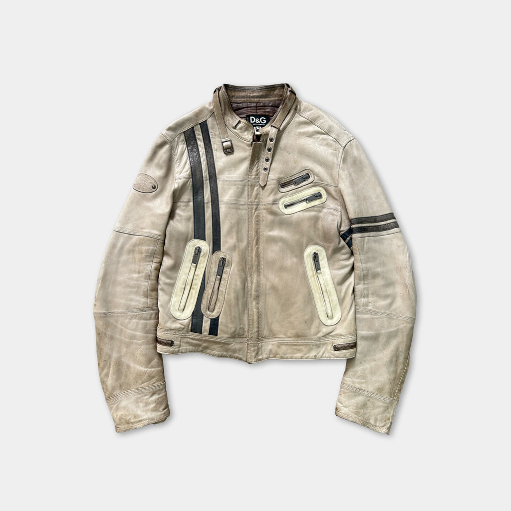 A tan leather jacket with black stripes and zippers, featuring a collar and multiple pockets.