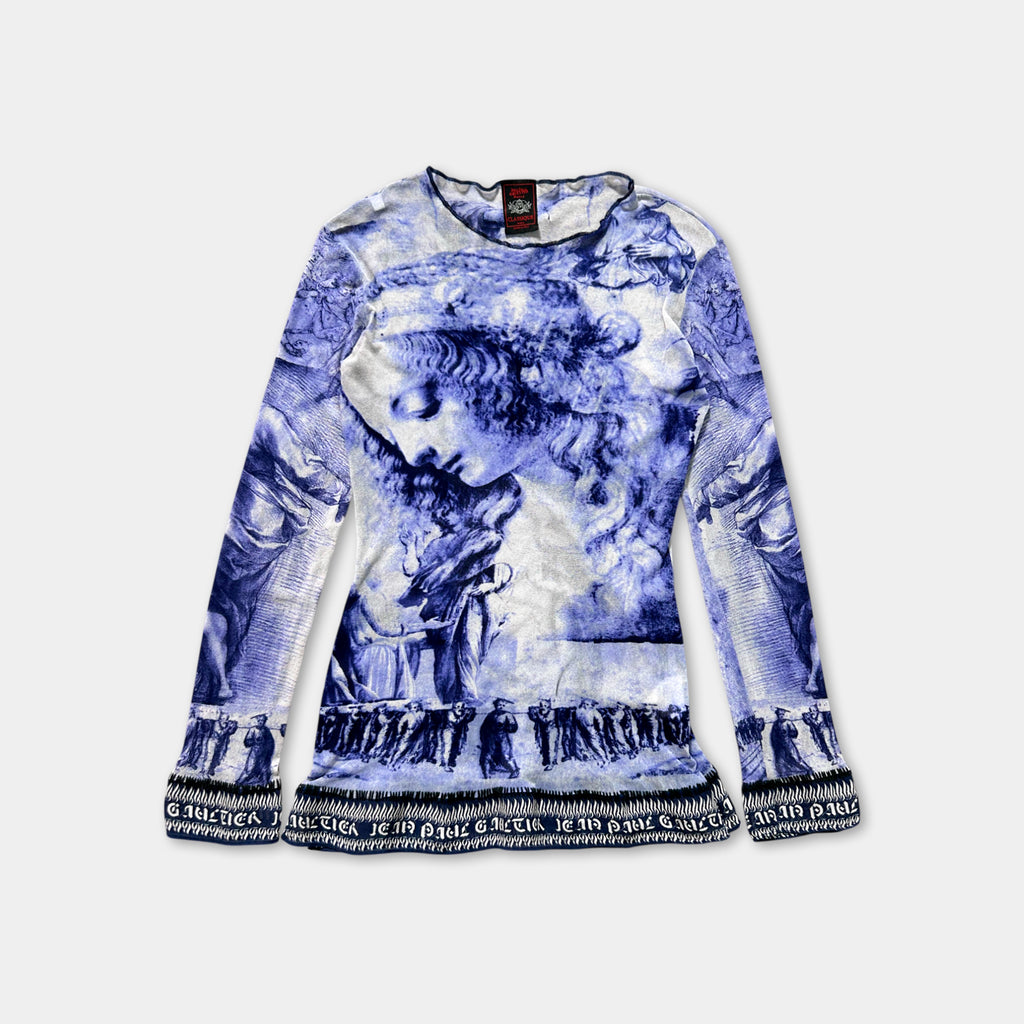 a long-sleeved top with a blue and white printed design depicting a woman's face.