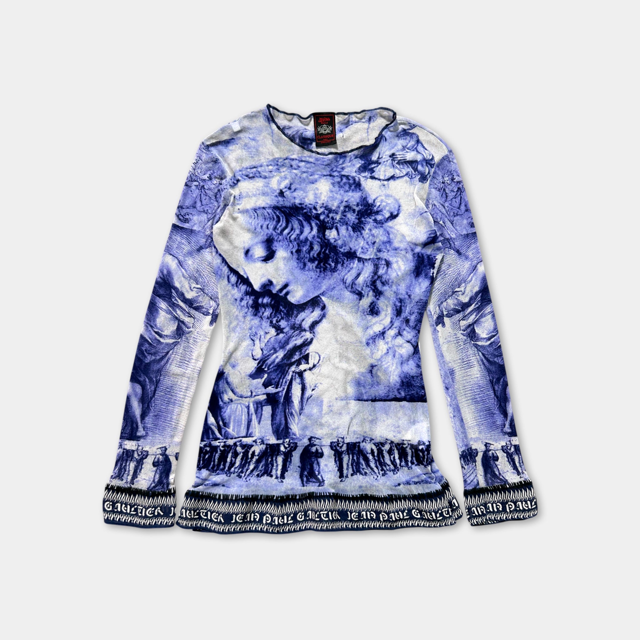 a long-sleeved top with a blue and white printed design depicting a woman's face.