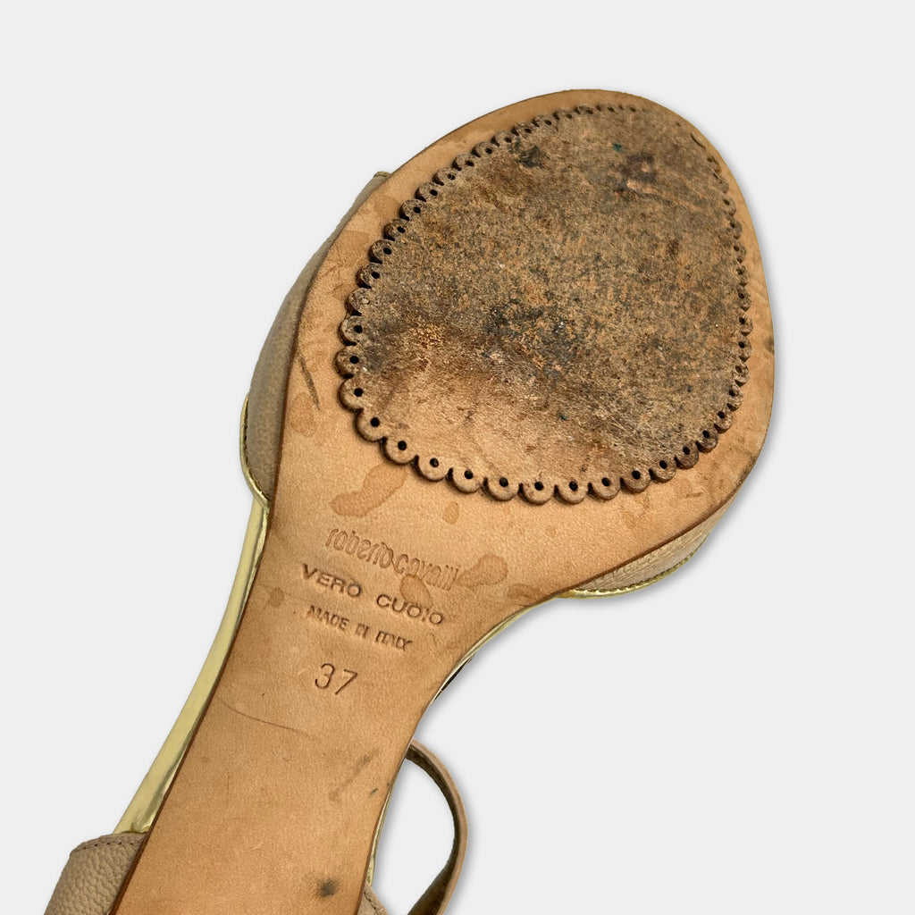 A close-up view of the sole of a worn and dirty shoe, showing the brand name and model information.