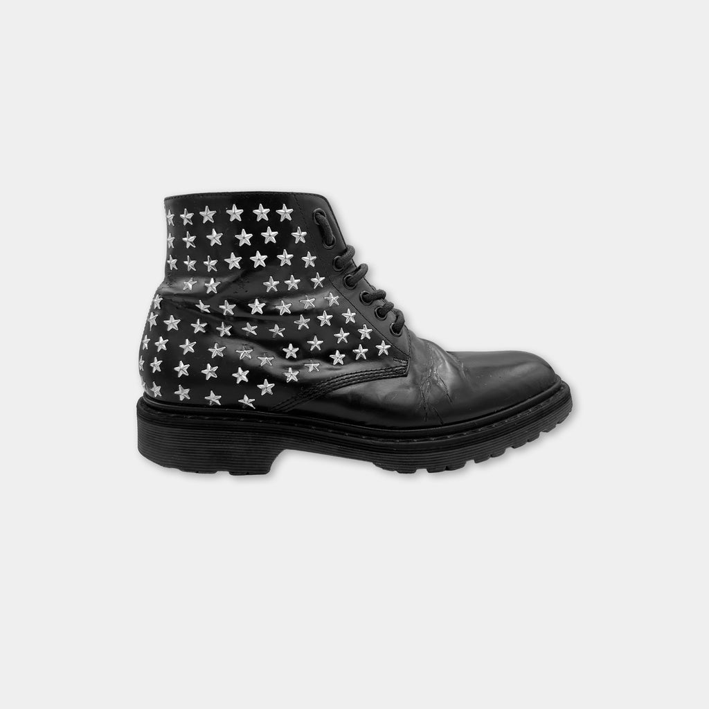 A black leather boot with white star patterns on the side.