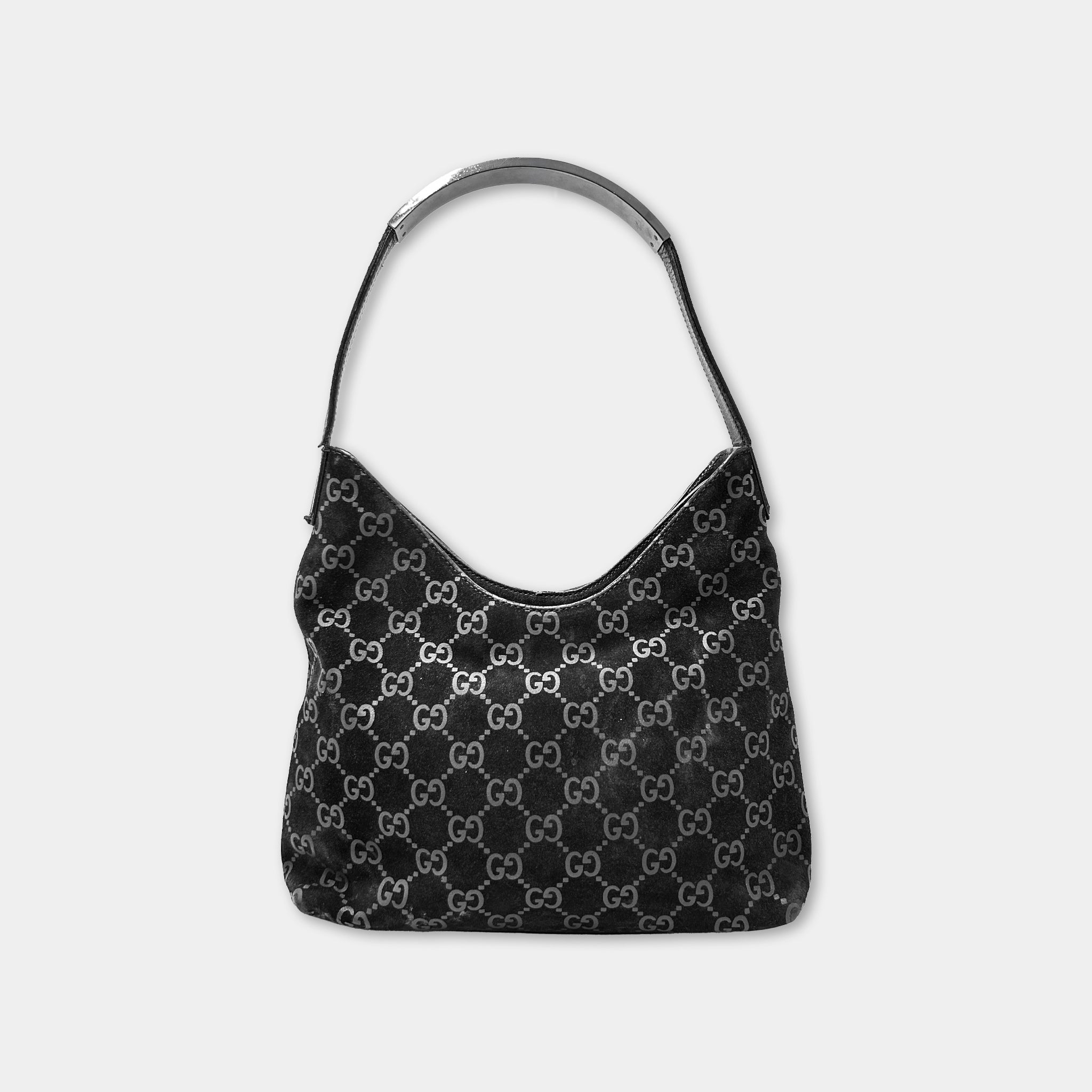 A black Gucci handbag with a distinctive monogram pattern.