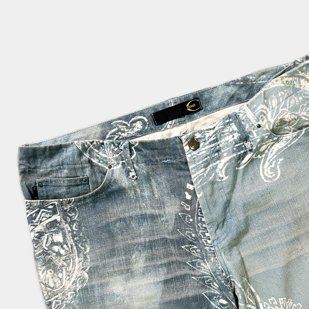 A pair of blue jeans with a paisley print pattern.
