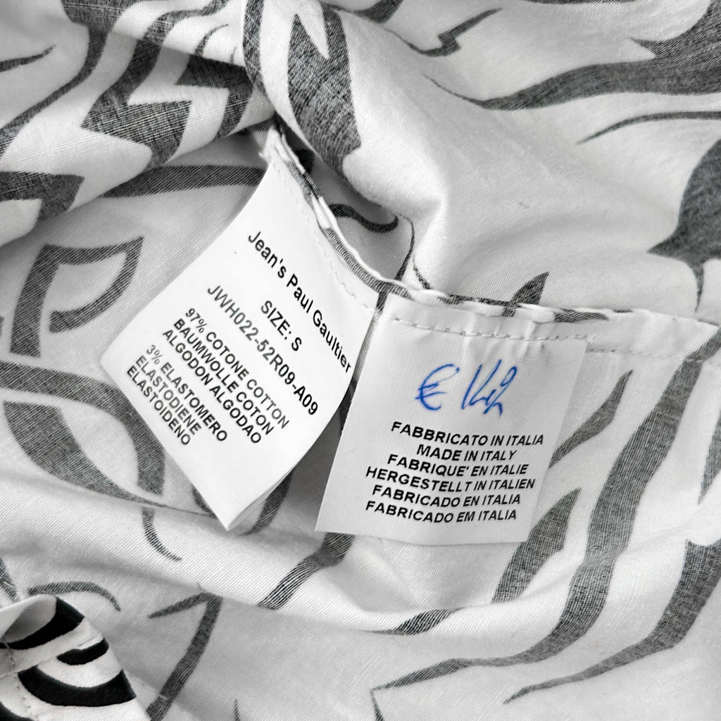 a close-up view of a fabric label with text, likely providing information about the fabric, such as its size, material, and origin.