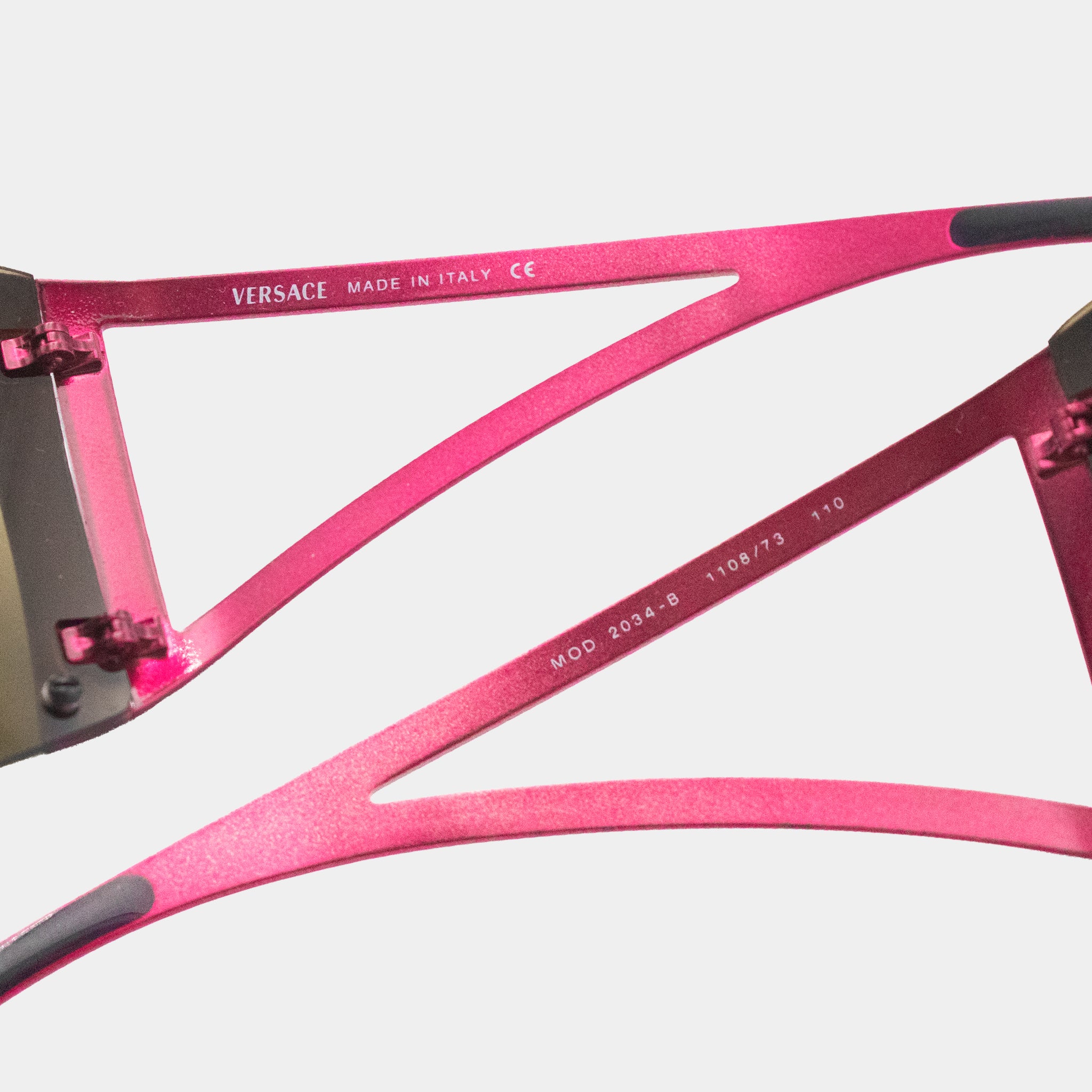 a pair of pink sunglasses with a black frame.