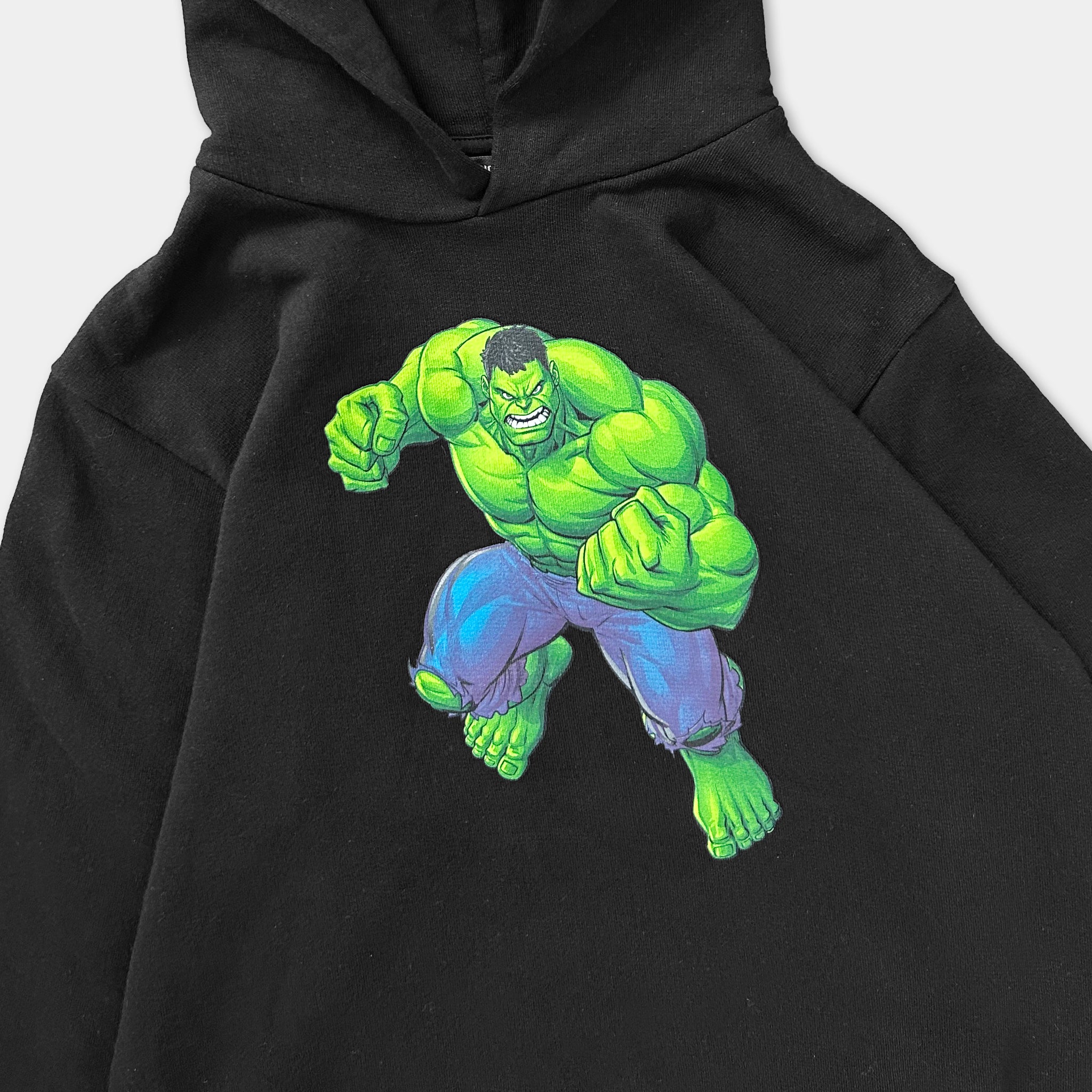 A black hoodie with a graphic of a muscular, green-skinned character with blue pants and a determined expression.