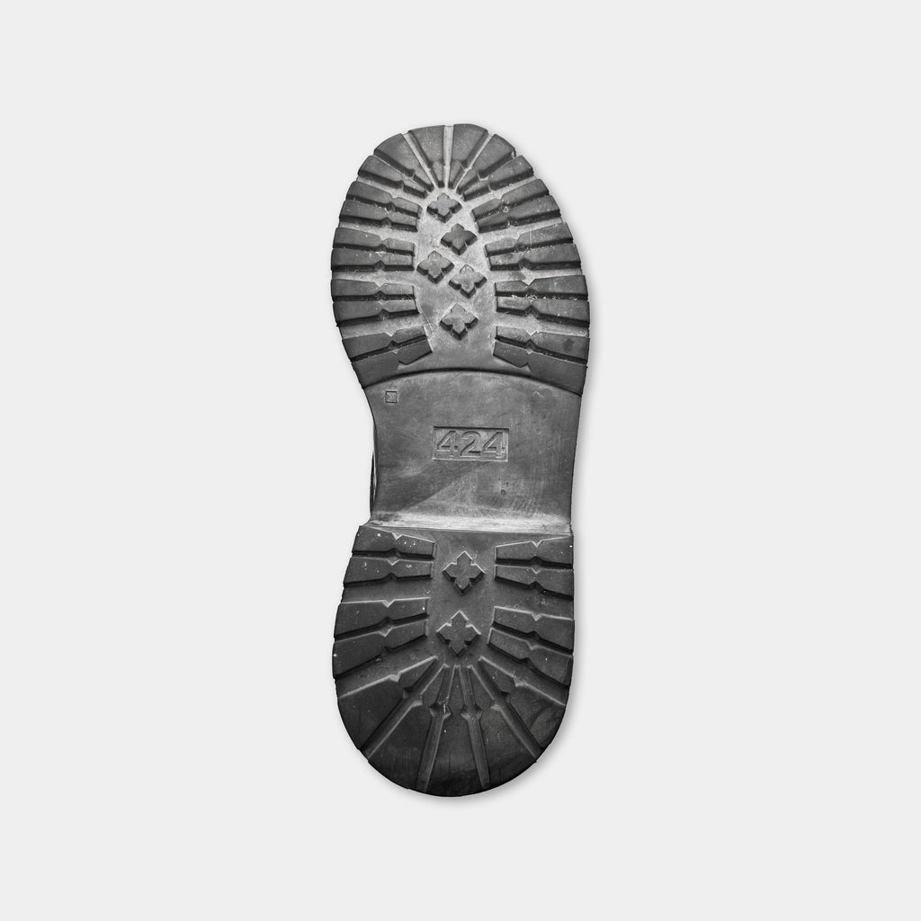 A black and white photograph of a sole of a shoe.