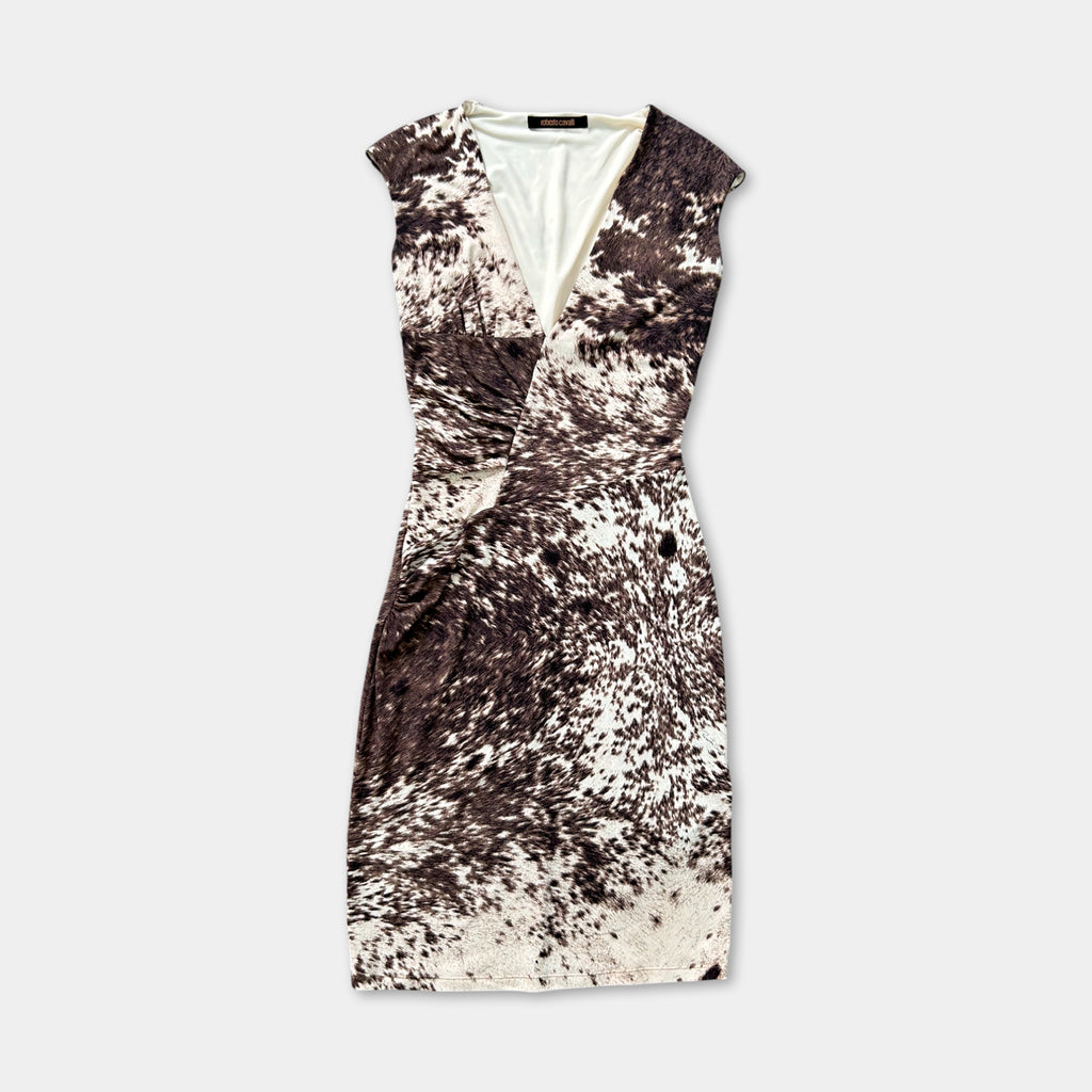 A sleeveless dress with a patterned design, featuring a v-neck and a tie at the neckline.