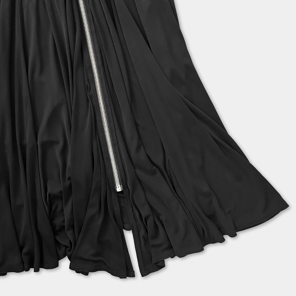 A close-up view of a black, flowing skirt with a zipper visible.
