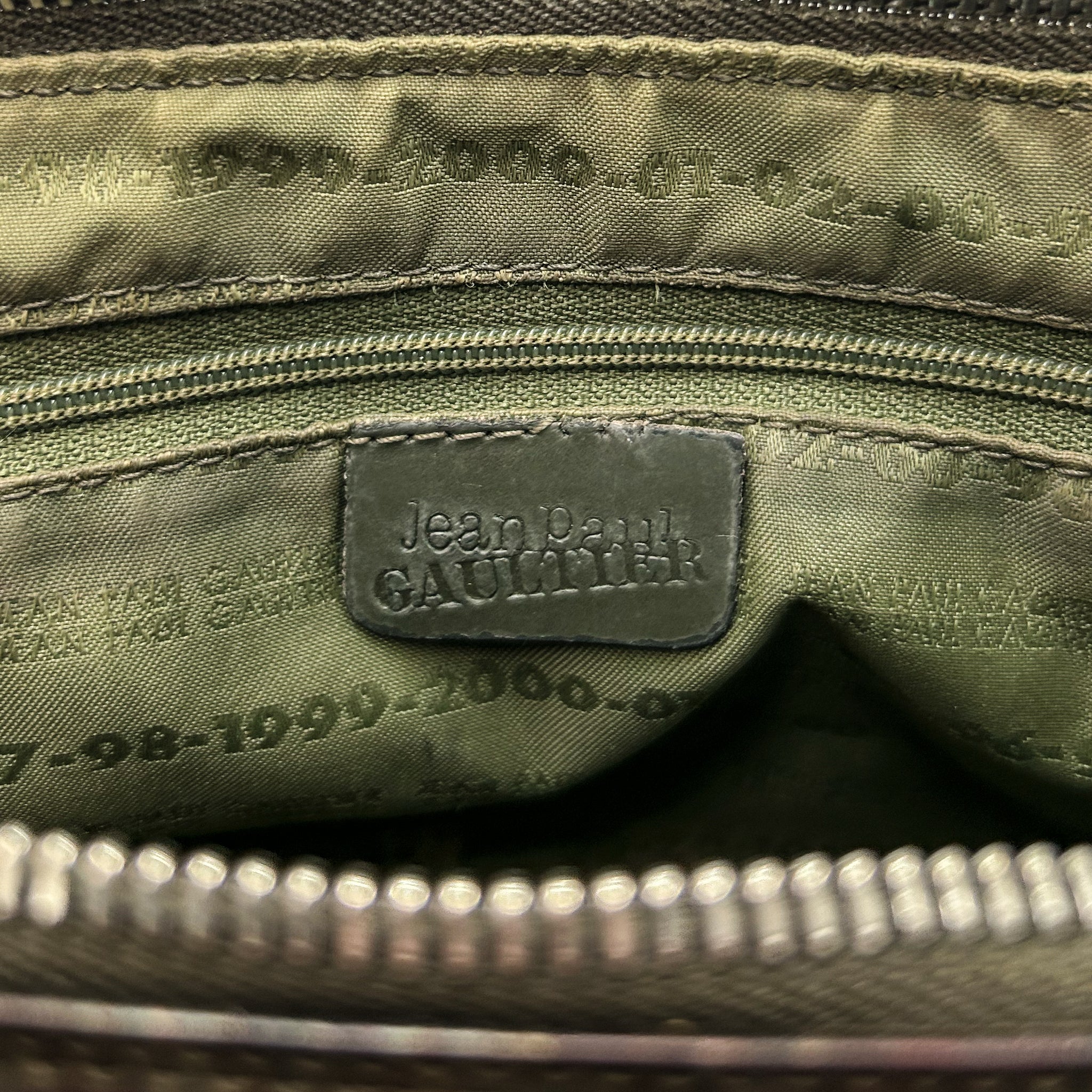 the interior of a bag, specifically the zipper and the label inside.