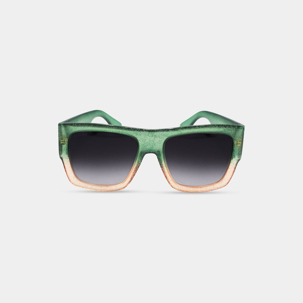 A pair of green and orange gradient sunglasses with black lenses.