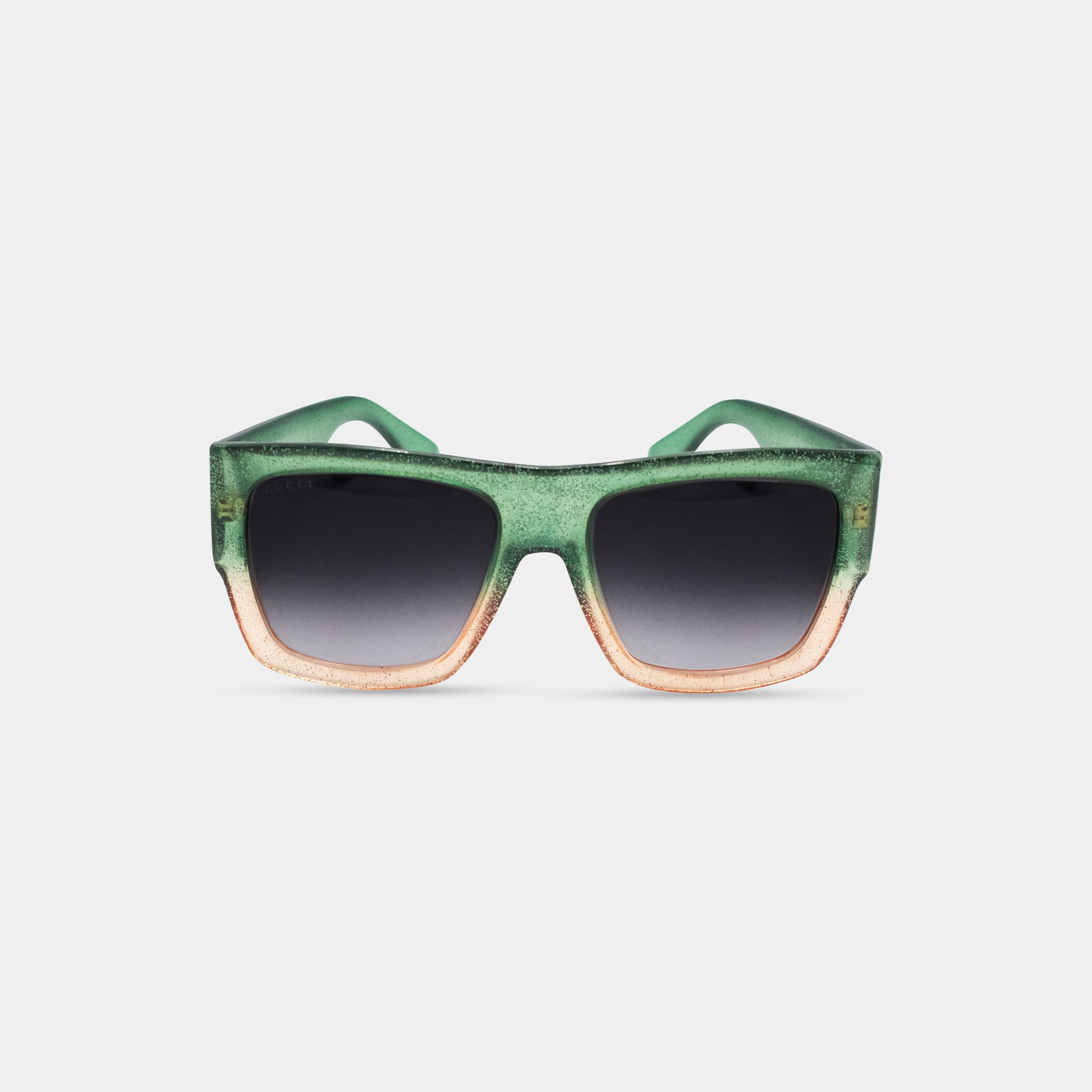 A pair of green and orange gradient sunglasses with black lenses.