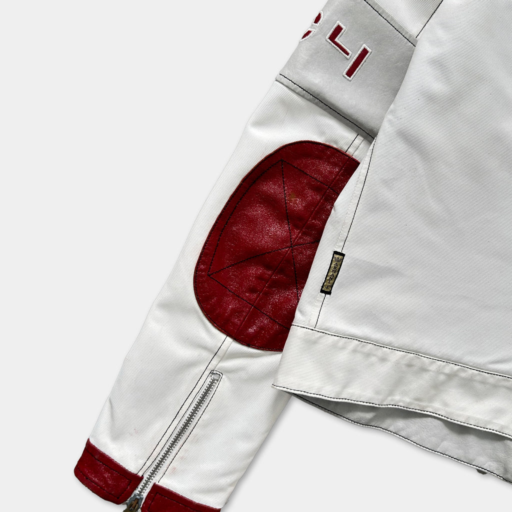 a close-up view of a white jacket with a red patch on the left side.