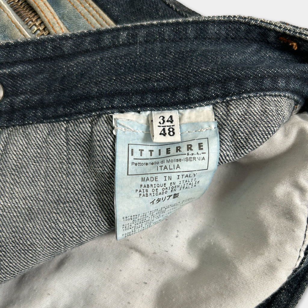 a close-up view of a denim fabric, specifically a pair of jeans, with a label attached to it. The label appears to be a label from a clothing brand, indicating the brand and possibly the model or size of the jeans.