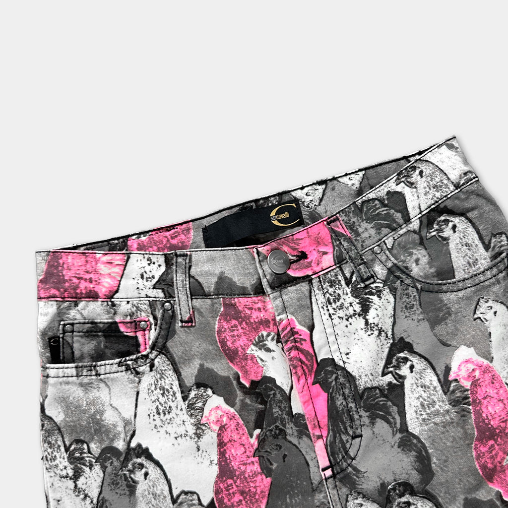 a pair of colorful, patterned jeans with a design of pink and black birds.