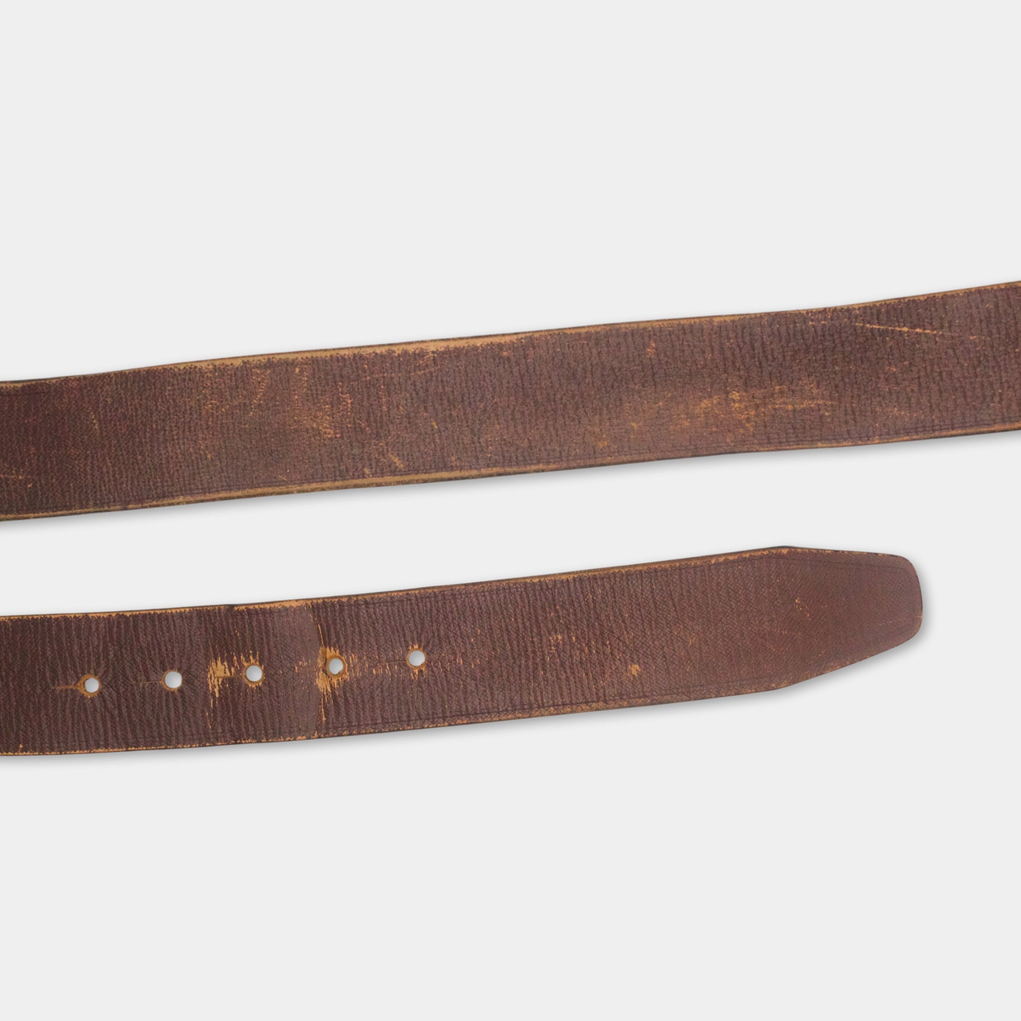 a close-up view of a brown leather belt with visible holes and a worn appearance.
