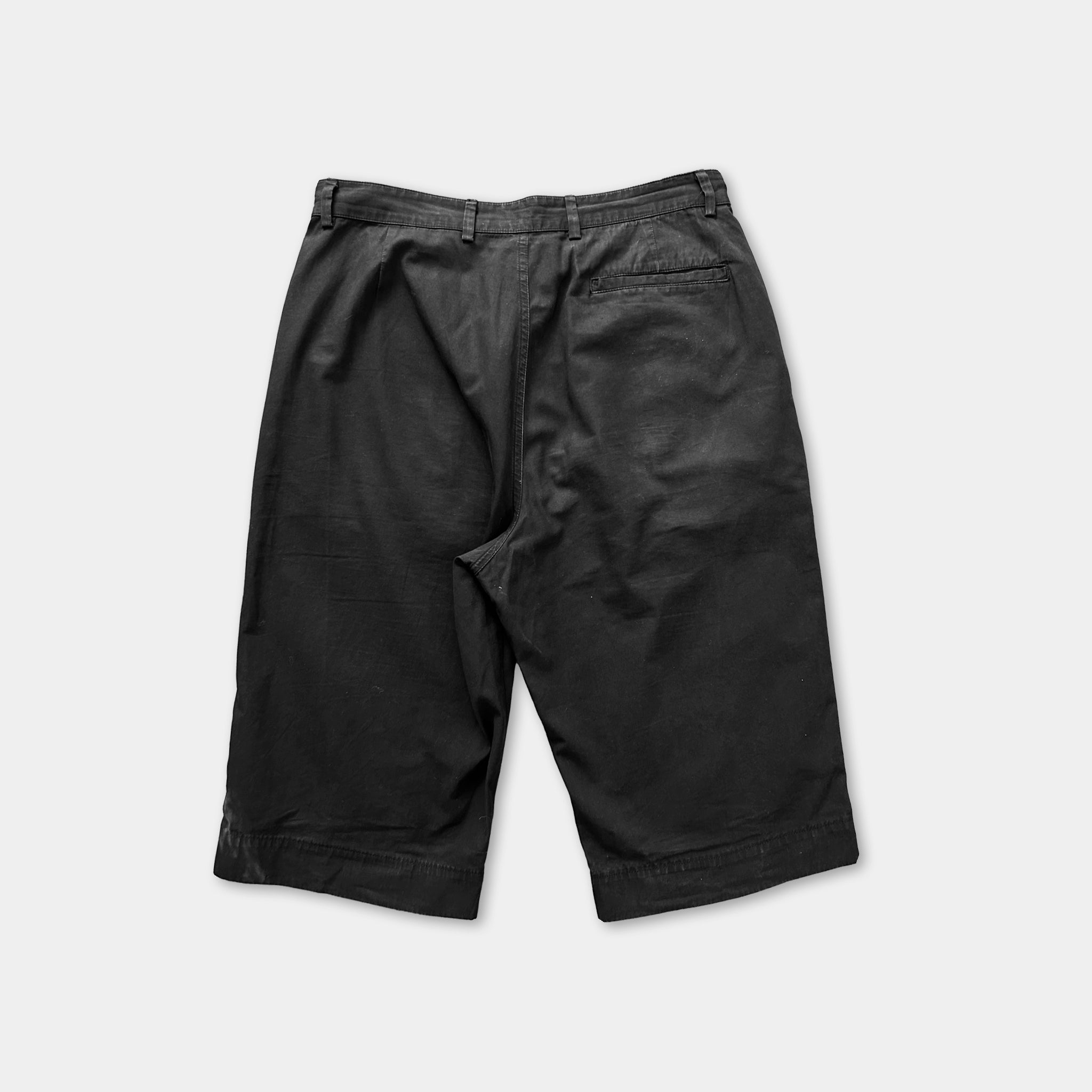 a pair of black shorts against a white background.