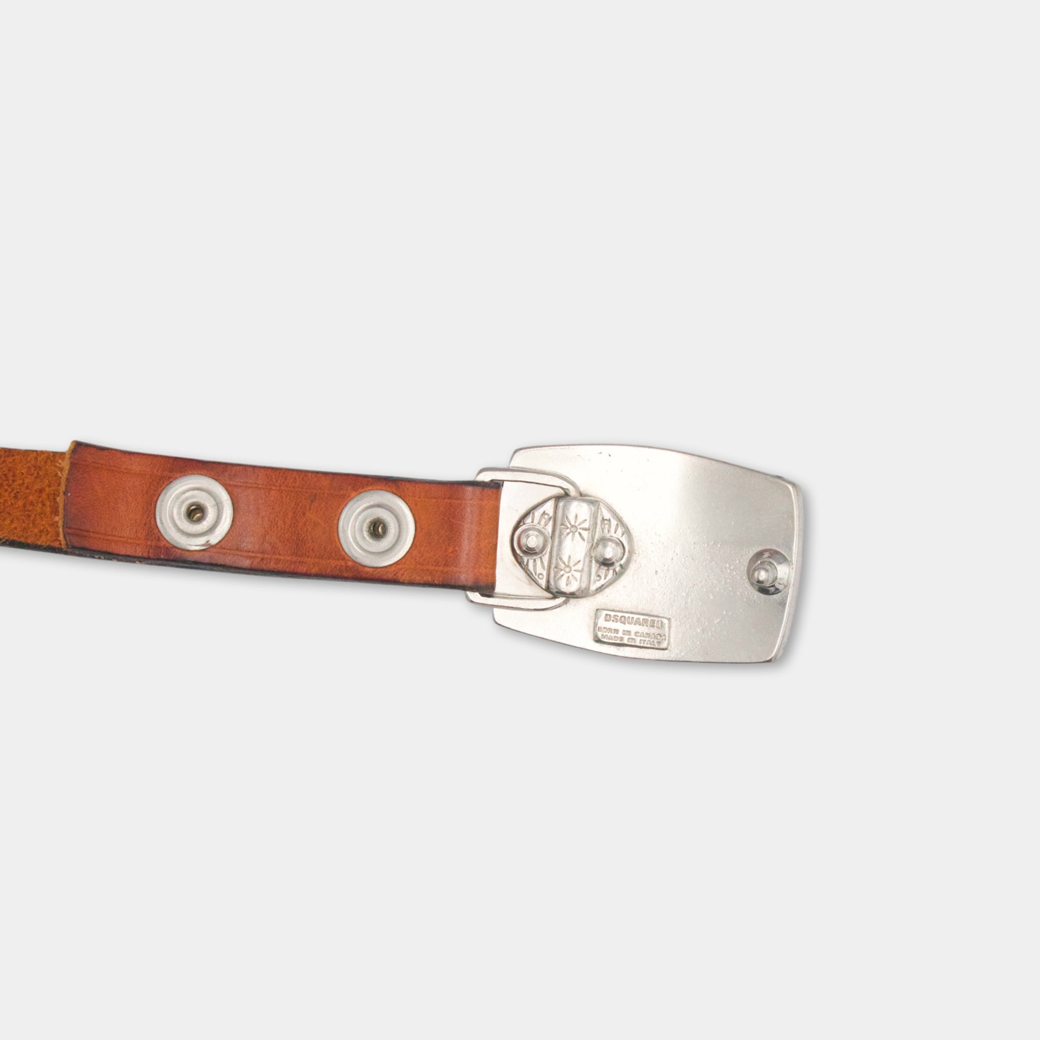 A brown leather belt with a silver buckle and two round buttons.