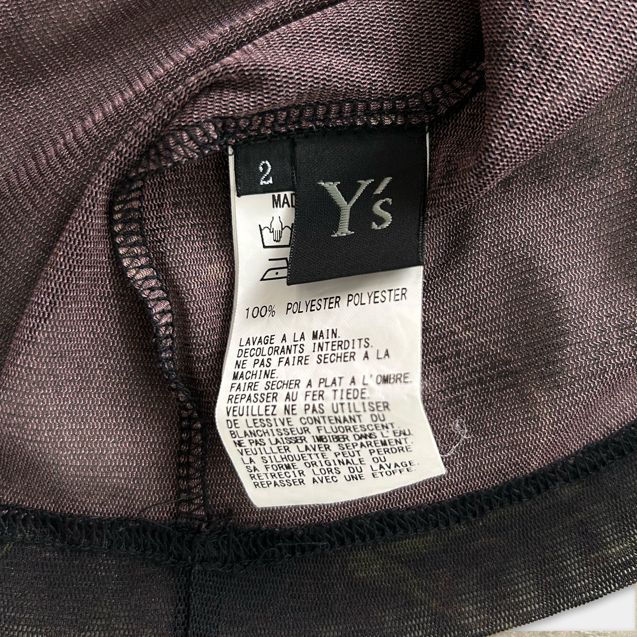a close-up view of a fabric label on a clothing item, with a focus on the text and details of the label.