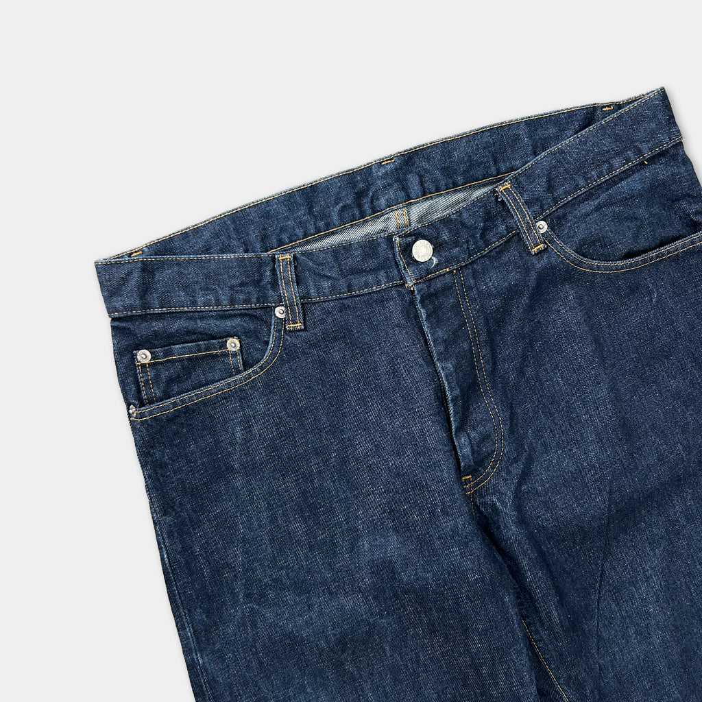 A pair of blue jeans with a button closure and pockets.