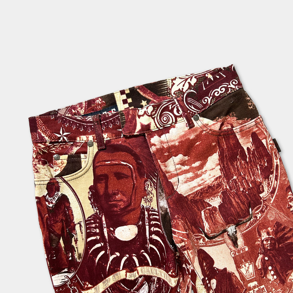 a pair of pants with a vibrant, colorful print featuring various images and patterns, including a man's face, a landscape, and other abstract designs.